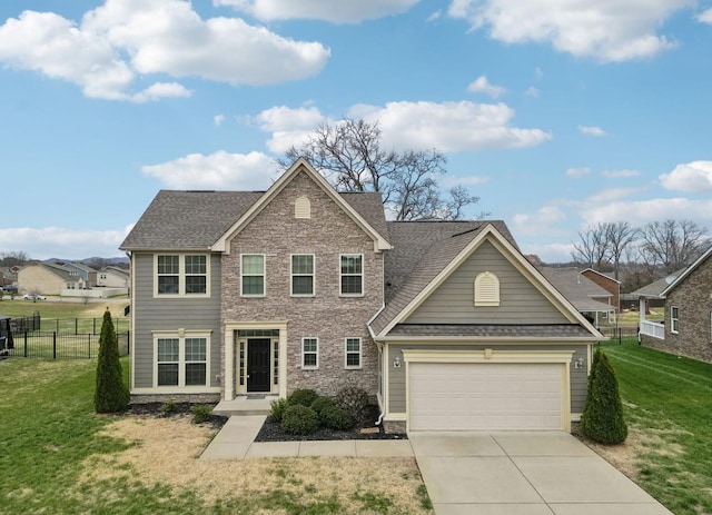 view of front of property featuring a front yard and a garage