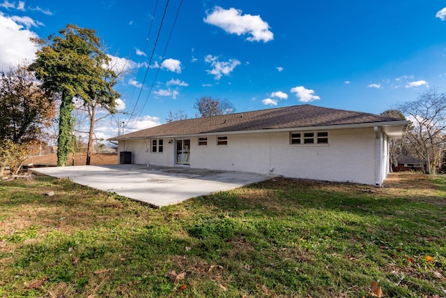 rear view of property with a yard and a patio