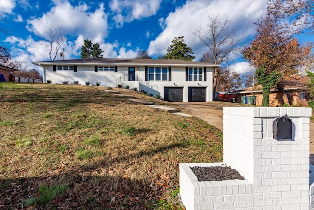 view of front facade with a garage and a front lawn