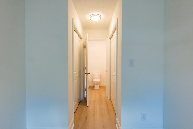 corridor with light hardwood / wood-style flooring