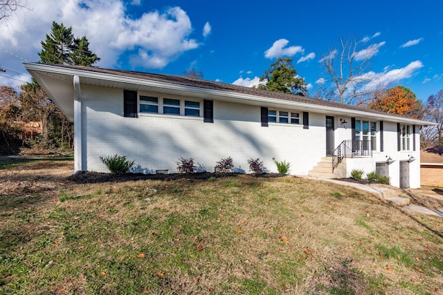 ranch-style house with a front lawn