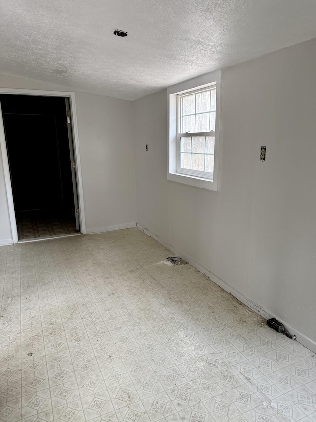 empty room featuring a textured ceiling