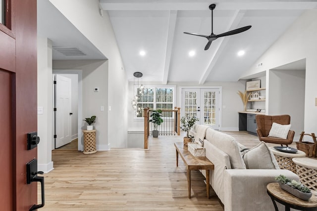 living room with french doors, light wood-type flooring, ceiling fan, high vaulted ceiling, and beamed ceiling