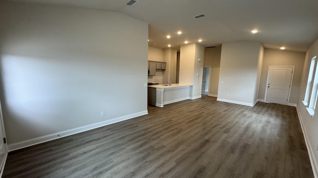 unfurnished living room featuring dark hardwood / wood-style flooring and lofted ceiling