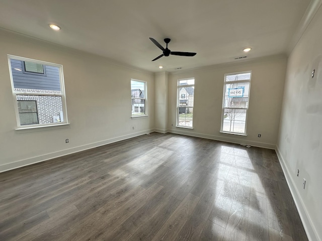 unfurnished room featuring ornamental molding, ceiling fan, and dark wood-type flooring