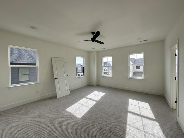 carpeted empty room featuring ceiling fan