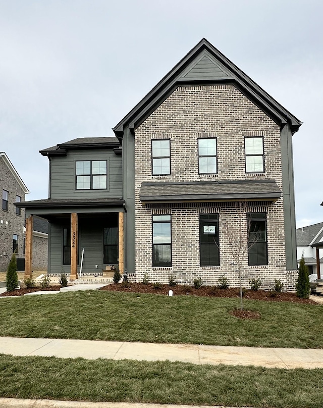 view of front of property featuring a front lawn and covered porch