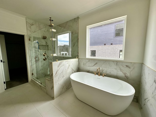 bathroom featuring tile patterned flooring, tile walls, and plus walk in shower