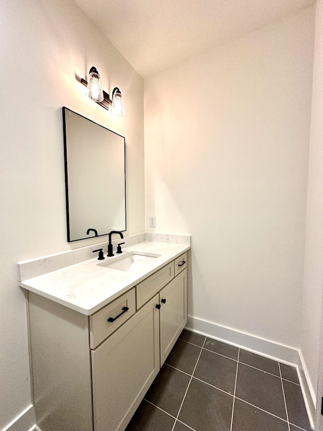 bathroom featuring vanity, baseboards, and tile patterned floors