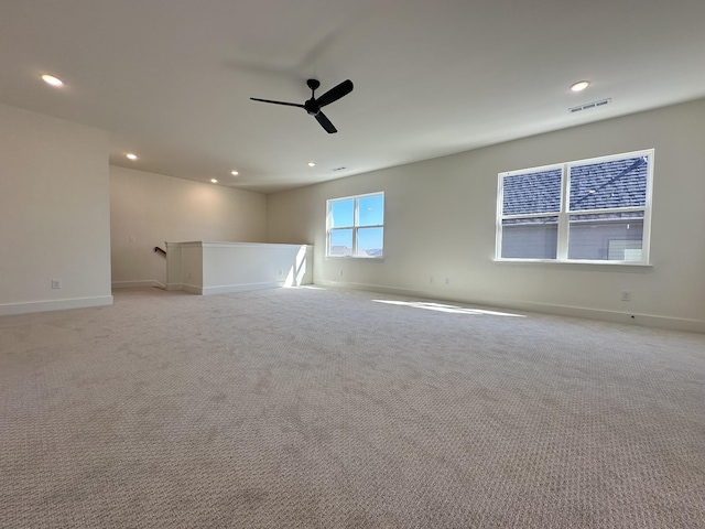 unfurnished room with recessed lighting, visible vents, light carpet, and baseboards