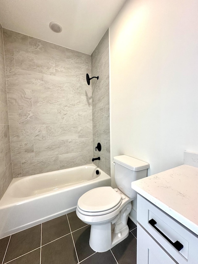 bathroom featuring toilet, vanity, tub / shower combination, and tile patterned floors