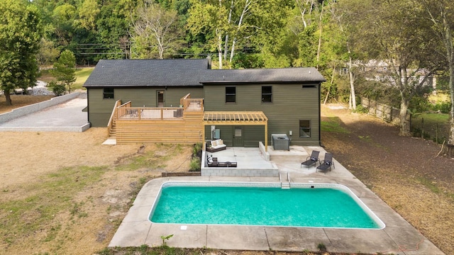 view of pool featuring central air condition unit, a wooden deck, and a patio