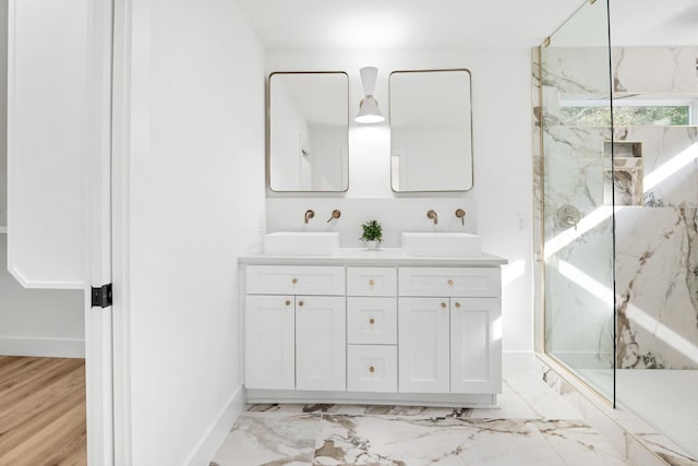 bathroom with vanity, a tile shower, and wood-type flooring