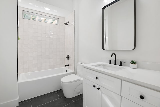 full bathroom with tile patterned floors, toilet, vanity, and tiled shower / bath