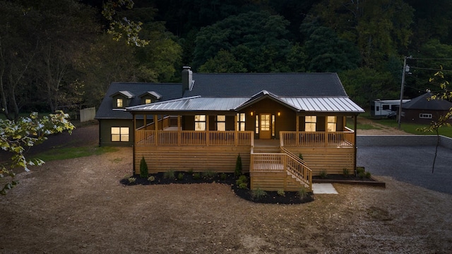 back of property with a porch