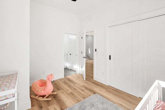 bedroom with wood-type flooring and a closet