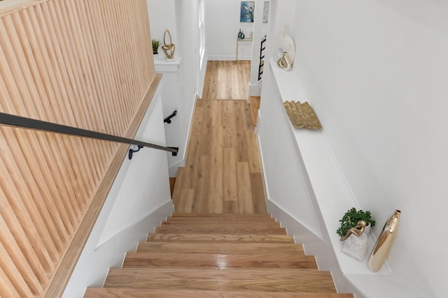 stairway featuring wood-type flooring