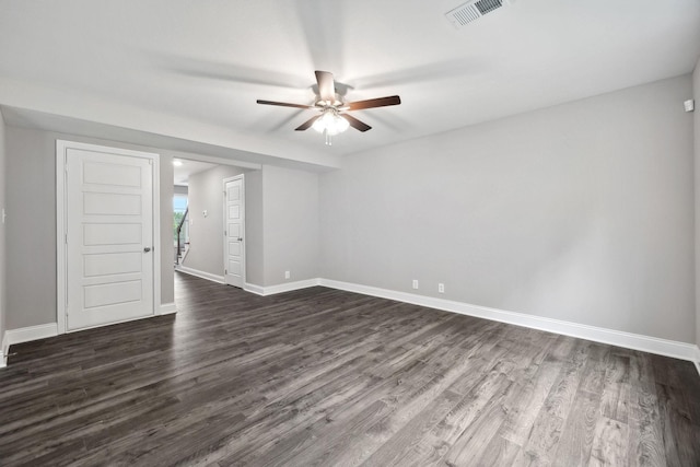 spare room with ceiling fan and dark hardwood / wood-style flooring