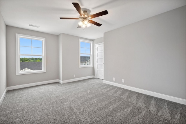 carpeted empty room featuring ceiling fan