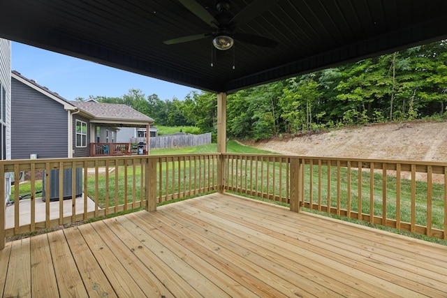 wooden deck featuring a yard and ceiling fan