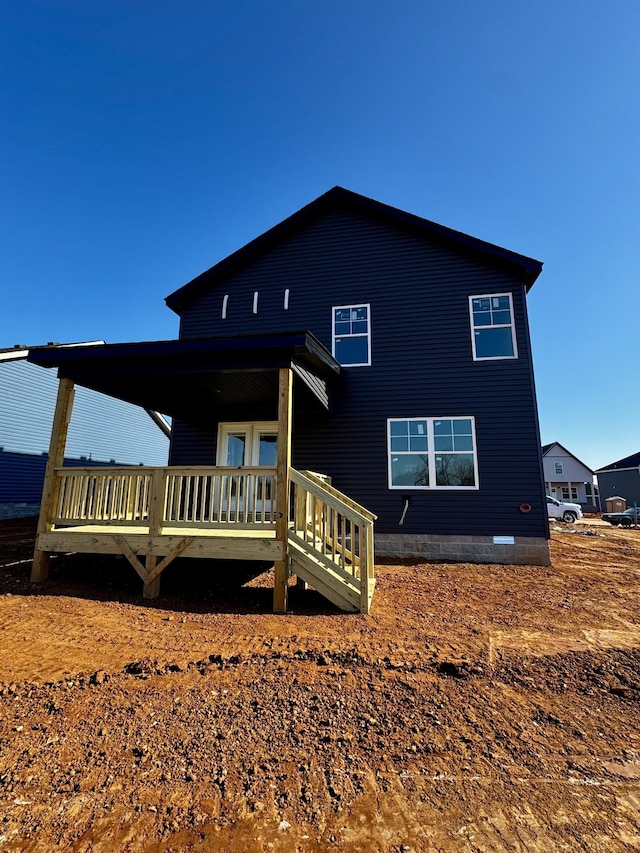 rear view of house featuring a wooden deck