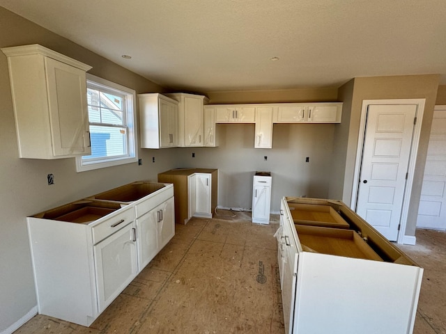 kitchen featuring a kitchen island and white cabinetry