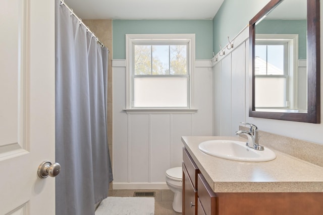 bathroom featuring tile patterned flooring, vanity, toilet, and a shower with shower curtain