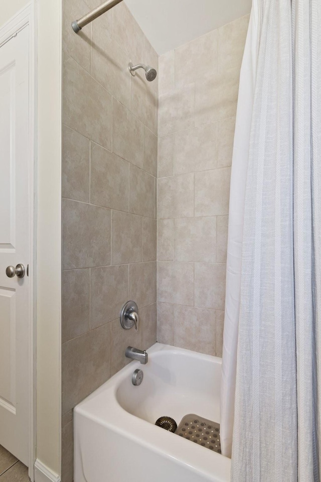 bathroom featuring tile patterned floors and shower / bath combo