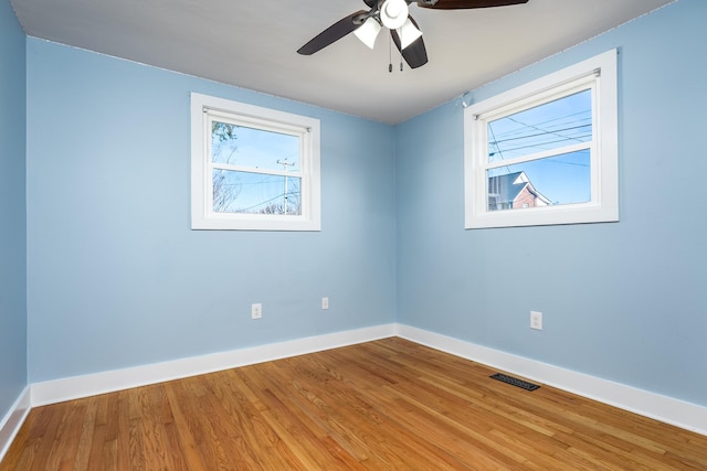 empty room featuring hardwood / wood-style flooring and ceiling fan