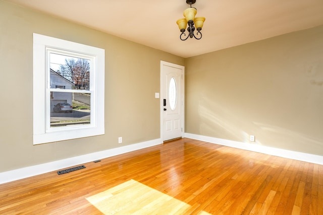 interior space featuring hardwood / wood-style flooring and a chandelier