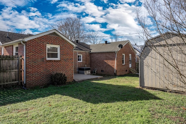 back of property featuring a yard and a patio