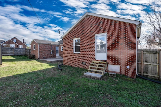 rear view of property with a yard