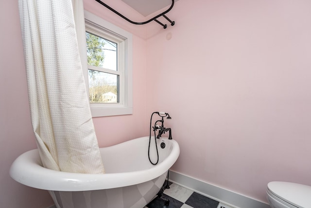 bathroom with a bathing tub and toilet