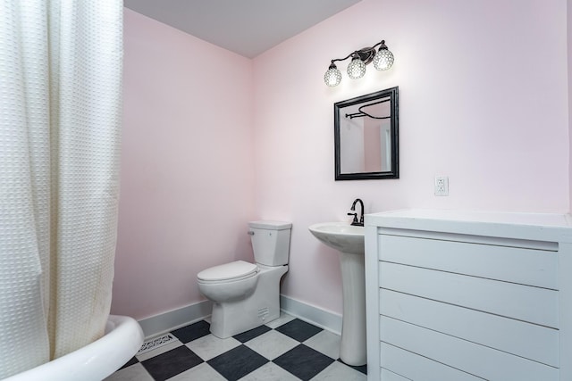 bathroom with curtained shower and toilet