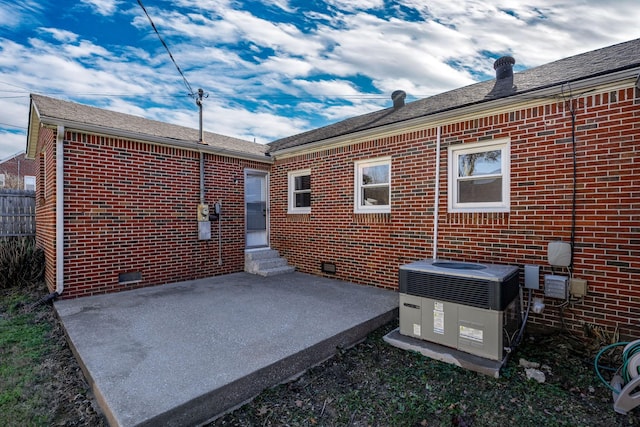 rear view of house featuring a patio and central air condition unit