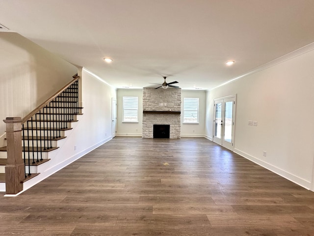 unfurnished living room with ceiling fan, dark wood-style flooring, stairs, and baseboards