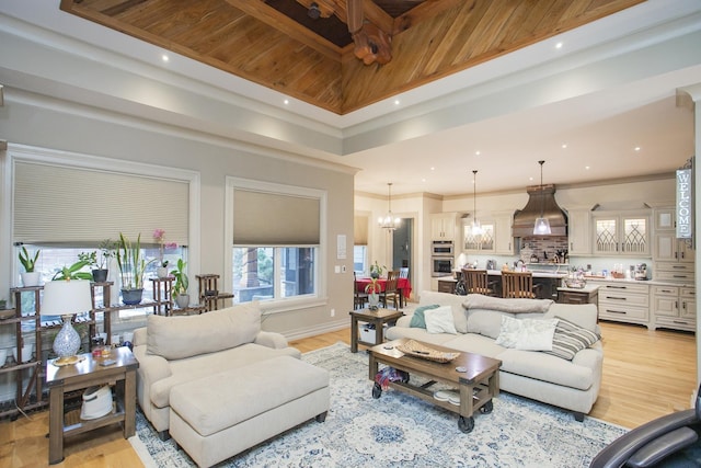 living room with crown molding, wooden ceiling, a chandelier, and light wood-type flooring