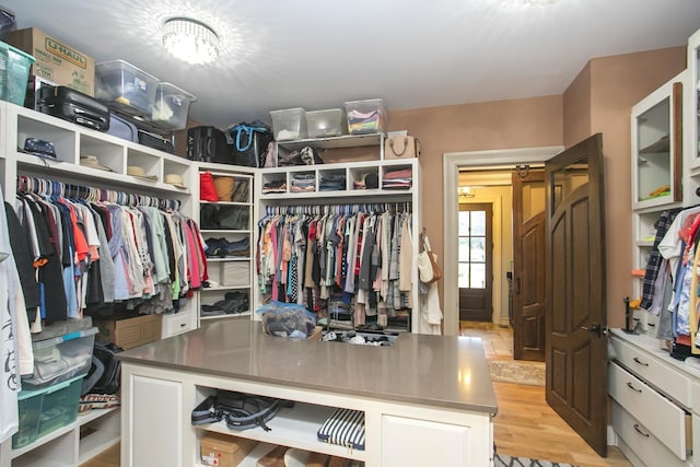 walk in closet with light wood-type flooring