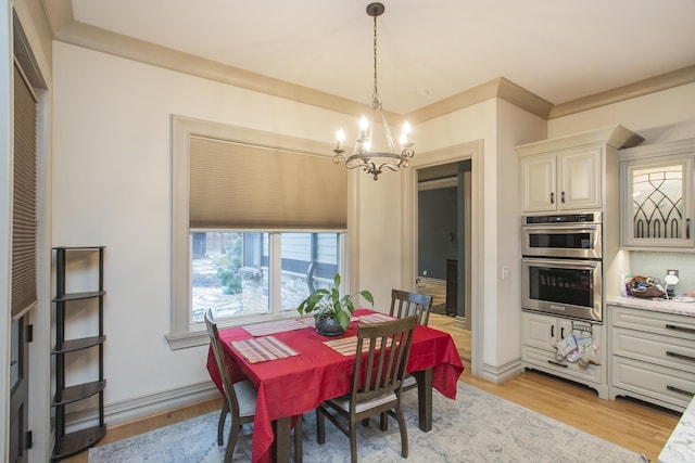 dining room featuring an inviting chandelier and light hardwood / wood-style floors