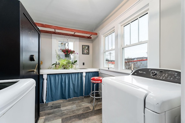 washroom with dark hardwood / wood-style floors and independent washer and dryer