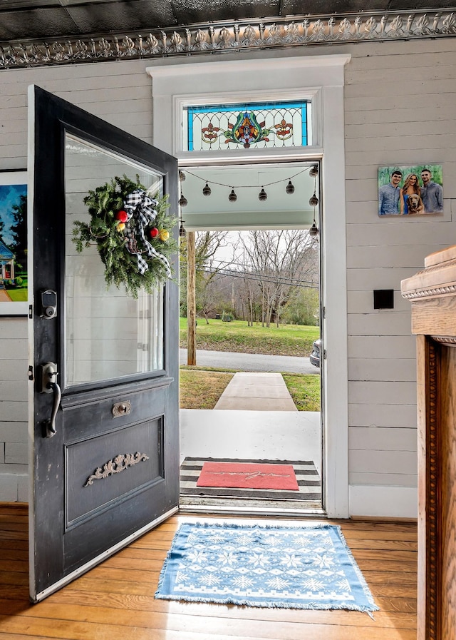 entryway featuring hardwood / wood-style floors and wood walls