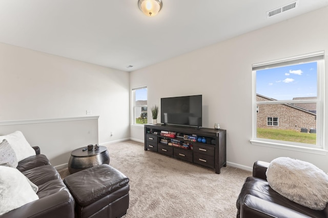 living room with light carpet and a healthy amount of sunlight