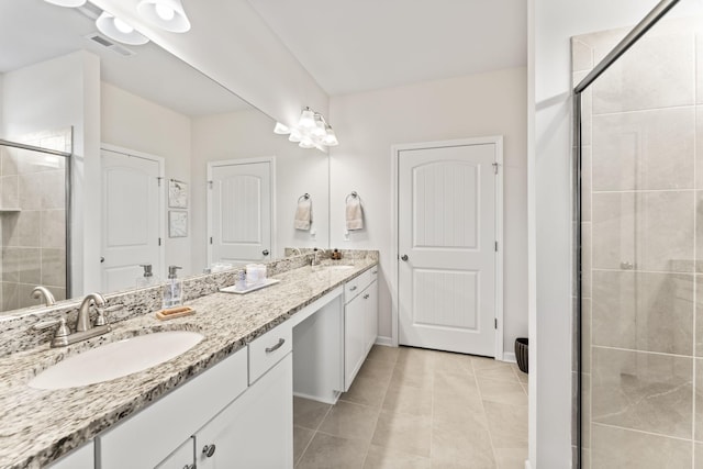 bathroom with vanity, tile patterned floors, and walk in shower