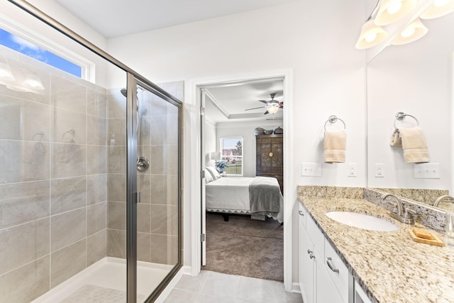 bathroom featuring tile patterned floors, vanity, ceiling fan, and a shower with shower door