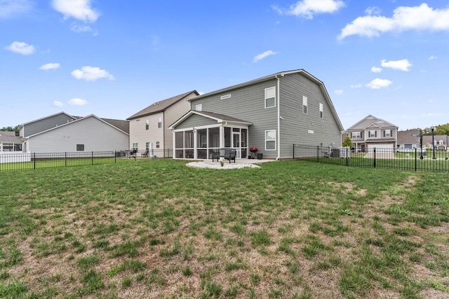 back of property featuring a sunroom, a yard, and a patio