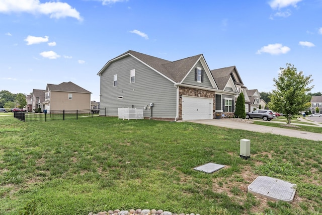 view of side of property featuring a lawn and a garage