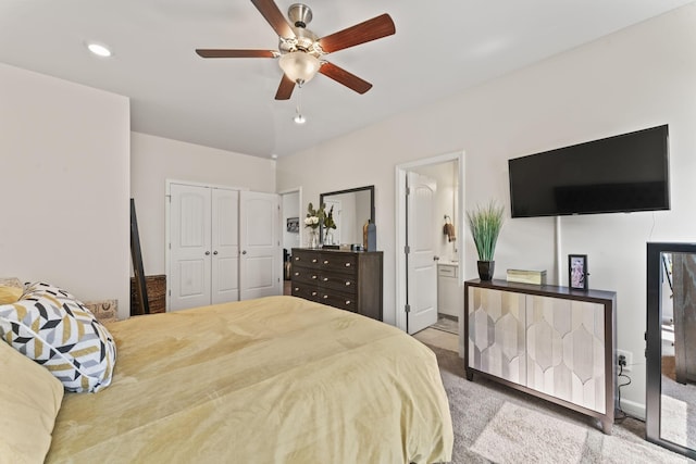 bedroom featuring carpet flooring, ceiling fan, a closet, and ensuite bath