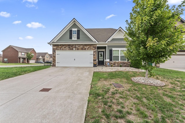 craftsman house with a garage and a front lawn