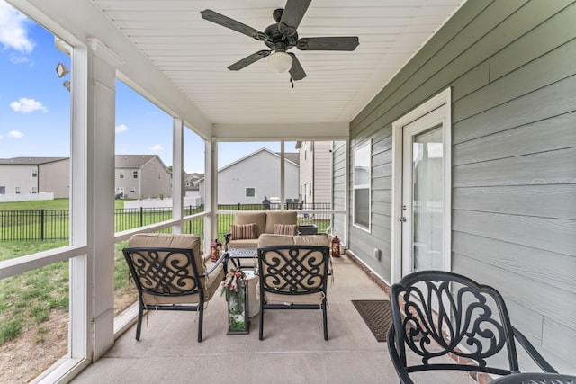 sunroom featuring ceiling fan and a healthy amount of sunlight