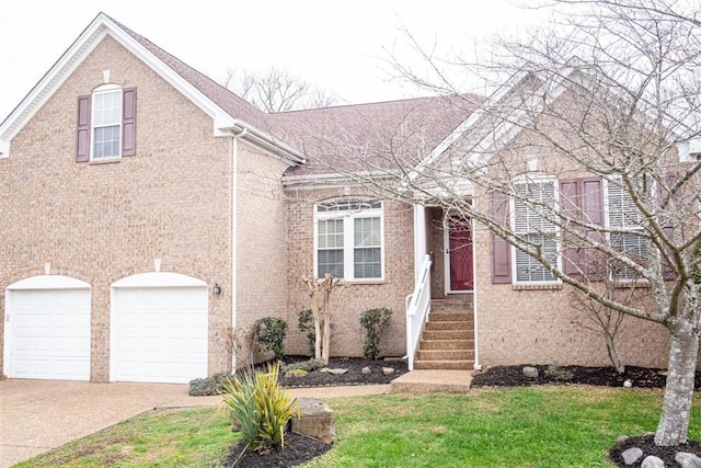 view of front of home with a garage and a front lawn